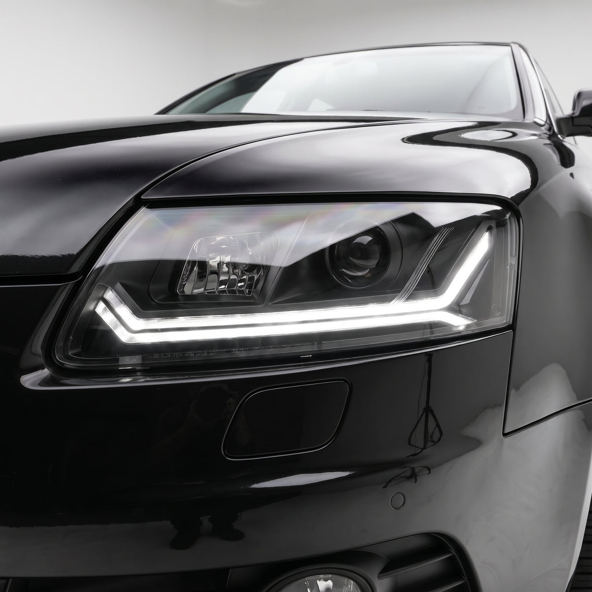 Audi A6 C6 (2004 - 2011) Sequential Black LED DRL Projector Headlights LH + RH installed close-up