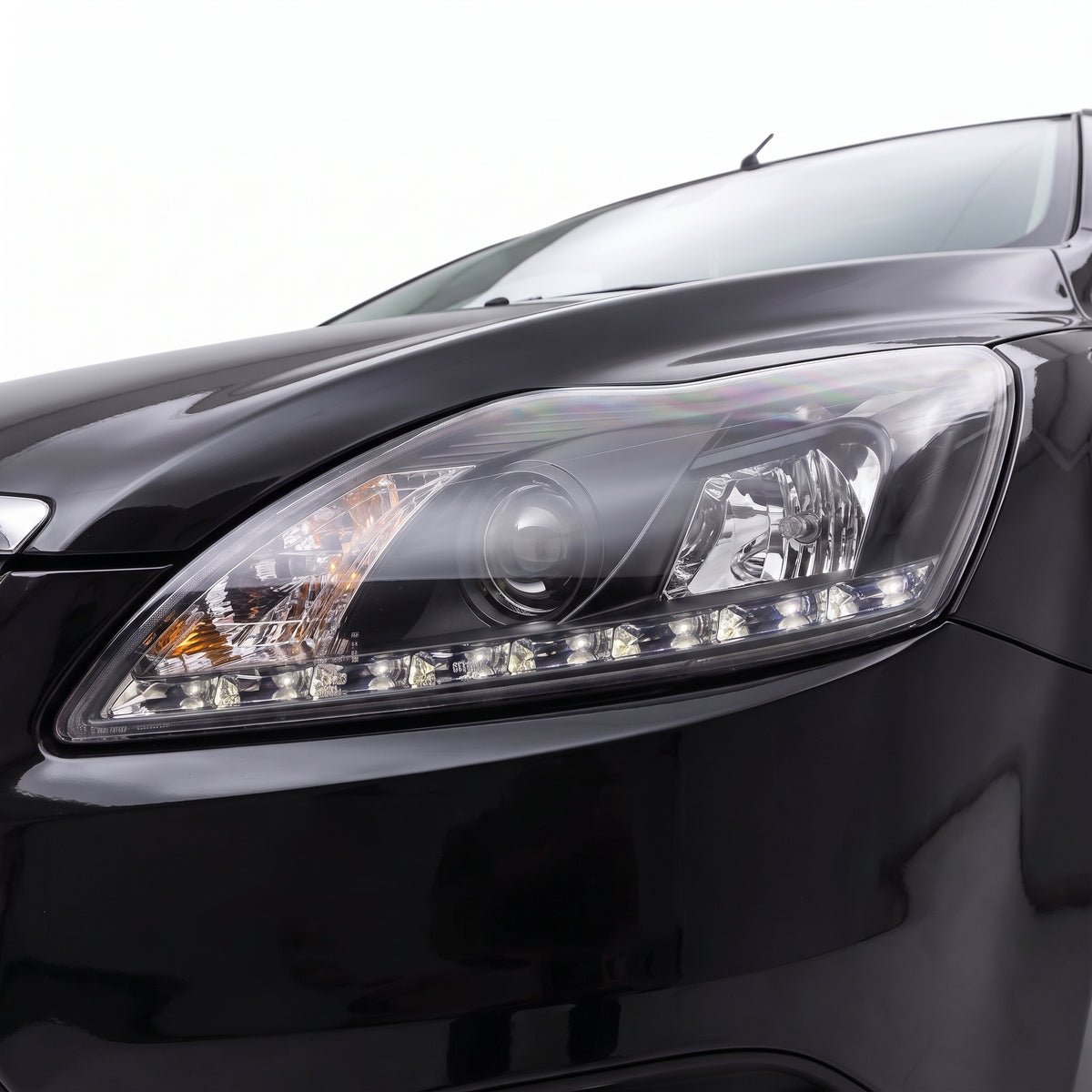 Ford Focus LV (2009 - 2011) Black Day Time DRL LED Projector Headlights LH + RH installed close-up