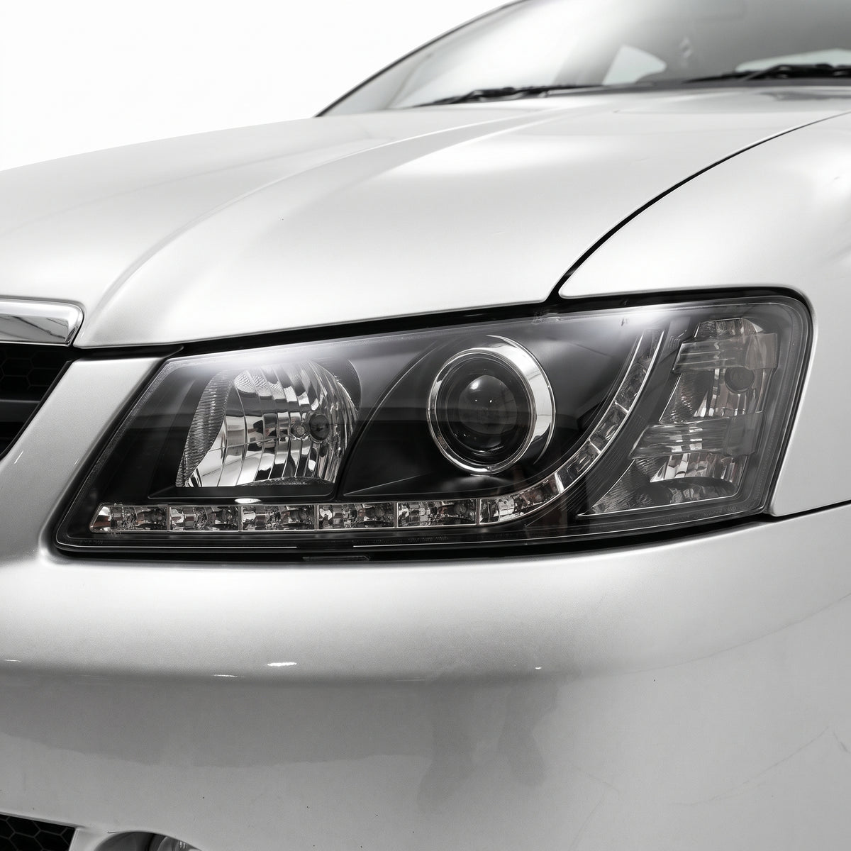 Holden Commodore VY (2002 - 2004) Black DRL LED Projector Headlights LH + RH installed close-up