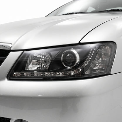 Holden Commodore VY (2002 - 2004) Black DRL LED Projector Headlights LH + RH installed close-up