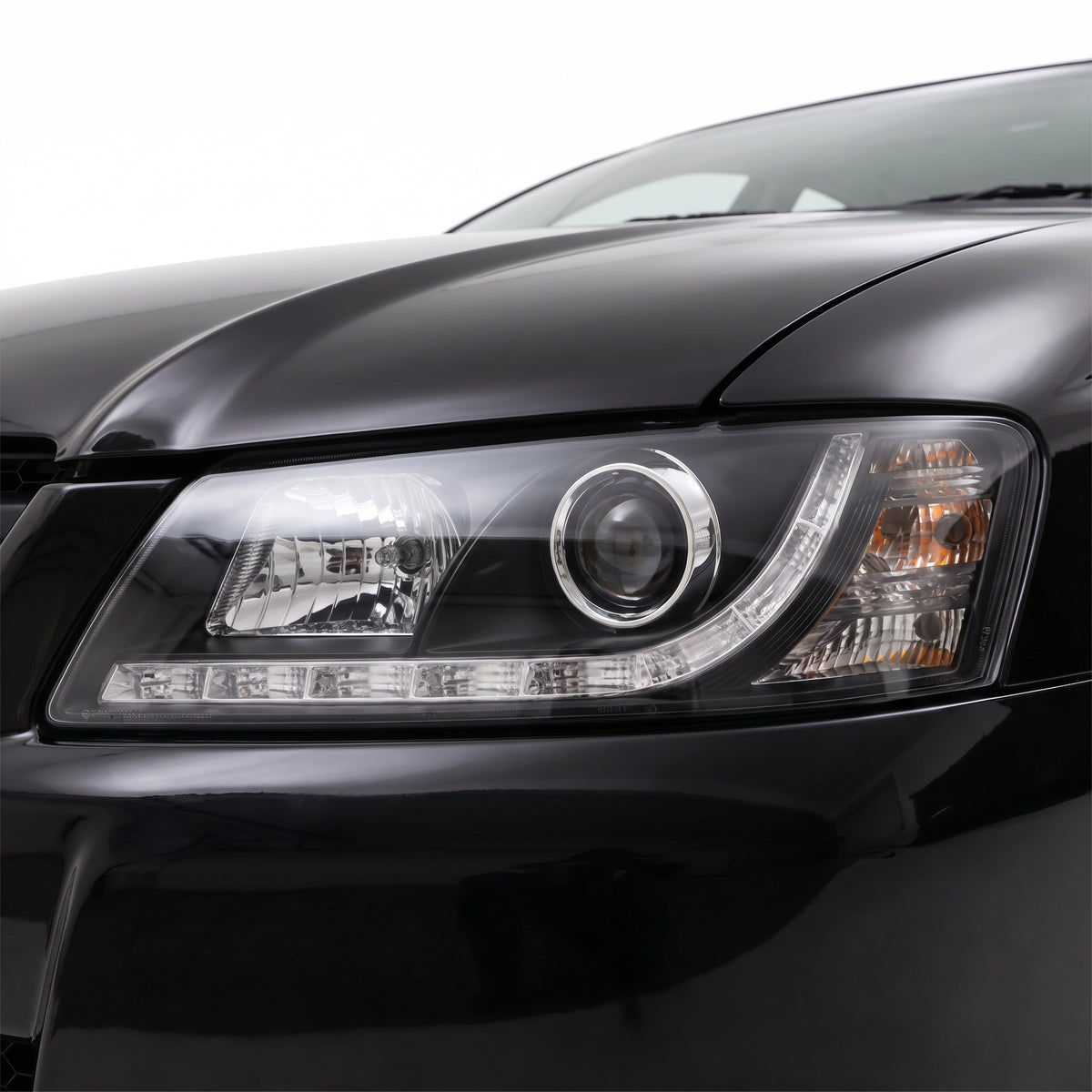 Holden Commodore VZ (2004 - 2007) Black DRL LED Projector Headlights LH + RH installed close-up