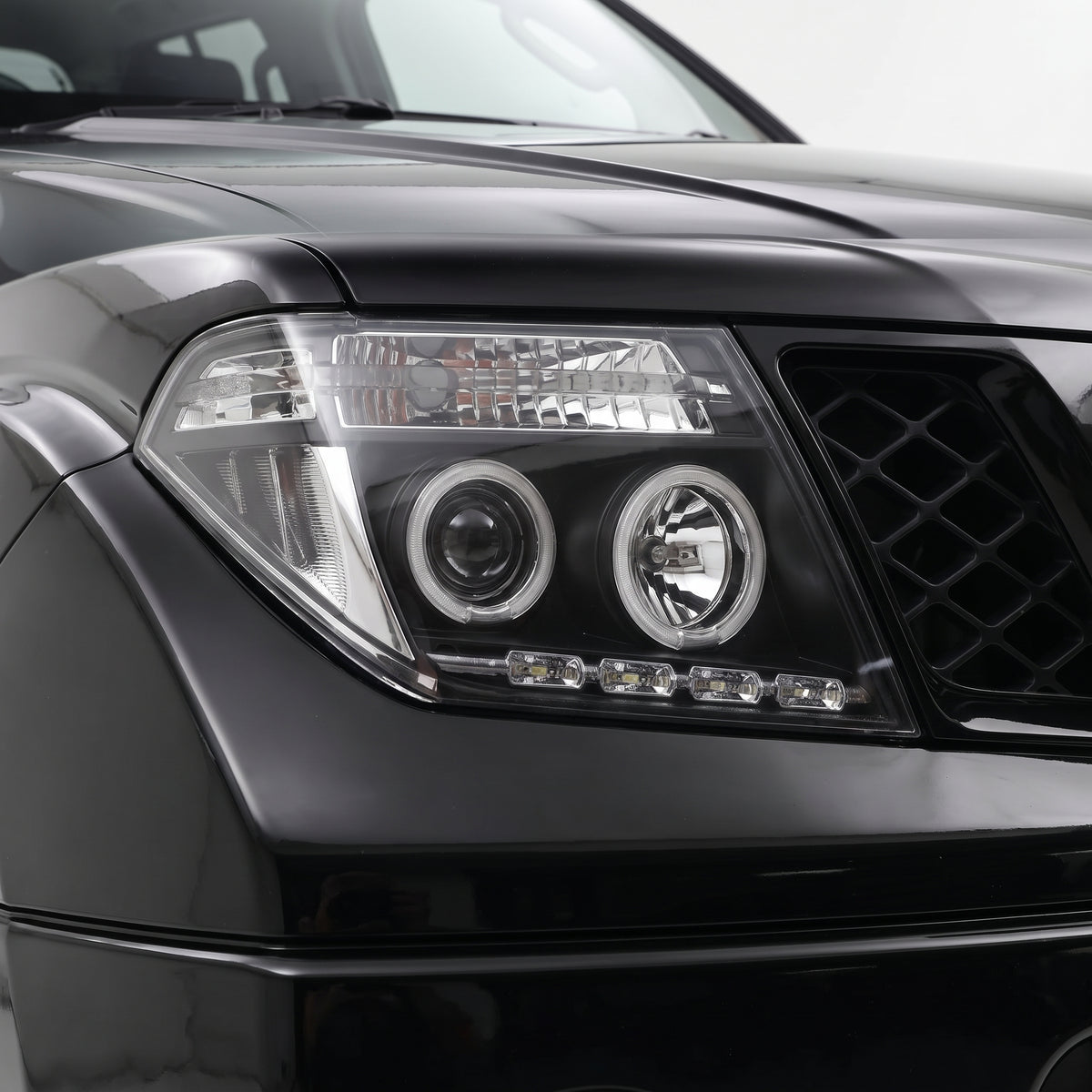 Nissan Navara D40 (2005 - 2014) Black CCFL Angel Eyes Projector Headlights LH + RH installed close-up
