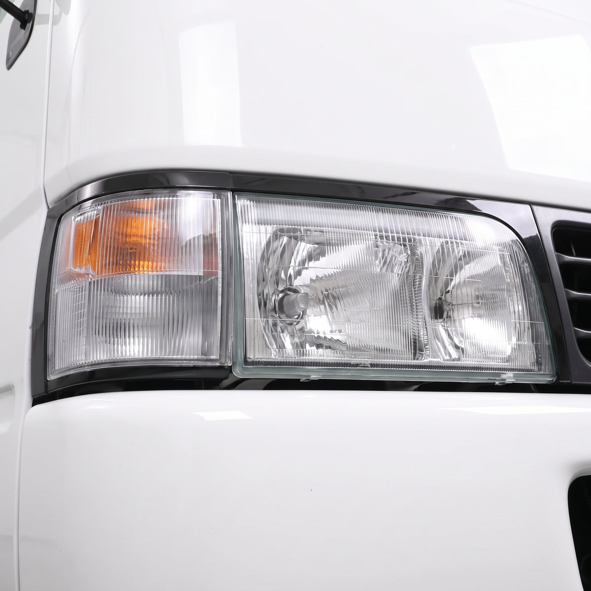 Toyota Coaster Bus BB40 / BB50 / HZB (1993 - 2006) Halogen OEM Style Headlights + Corner Lights LH + RH installed close-up