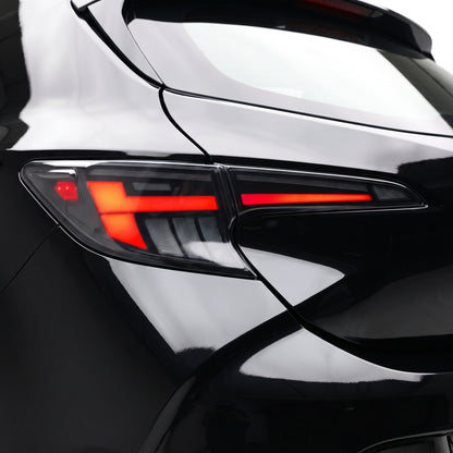 Toyota Corolla E210 Hatch (2019 - 2024) Black Red LED Sequential Tail Lights LH + RH installed close-up