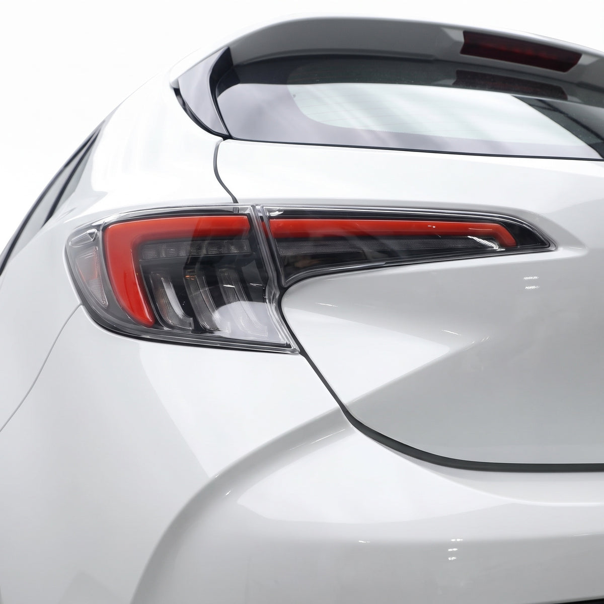 Toyota Corolla E210 Hatch (2019 - 2024) Smoked White LED Sequential Tail Lights LH + RH installed close-up