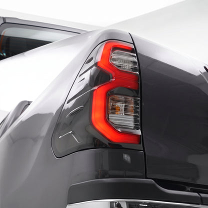 Toyota HiLux N80 / Revo Rocco (2015 - 2025) Smoked MY12 Update Style 3D LED Stripe Bar Tail Lights LH + RH installed close-up