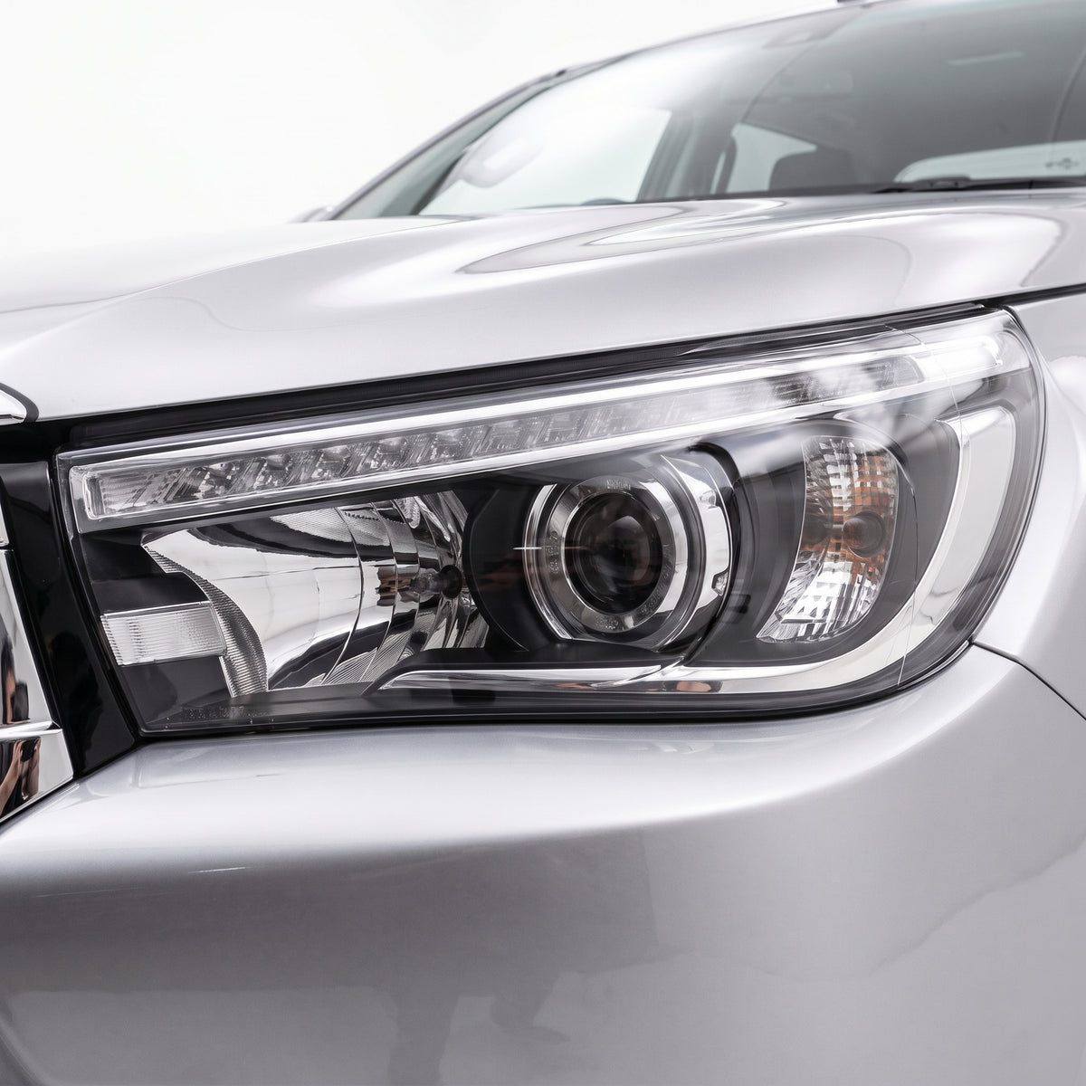 Toyota HiLux N80 (2015 - 2020) LED DRL Projector Headlights with Sequential Indicators LH + RH installed close-up
