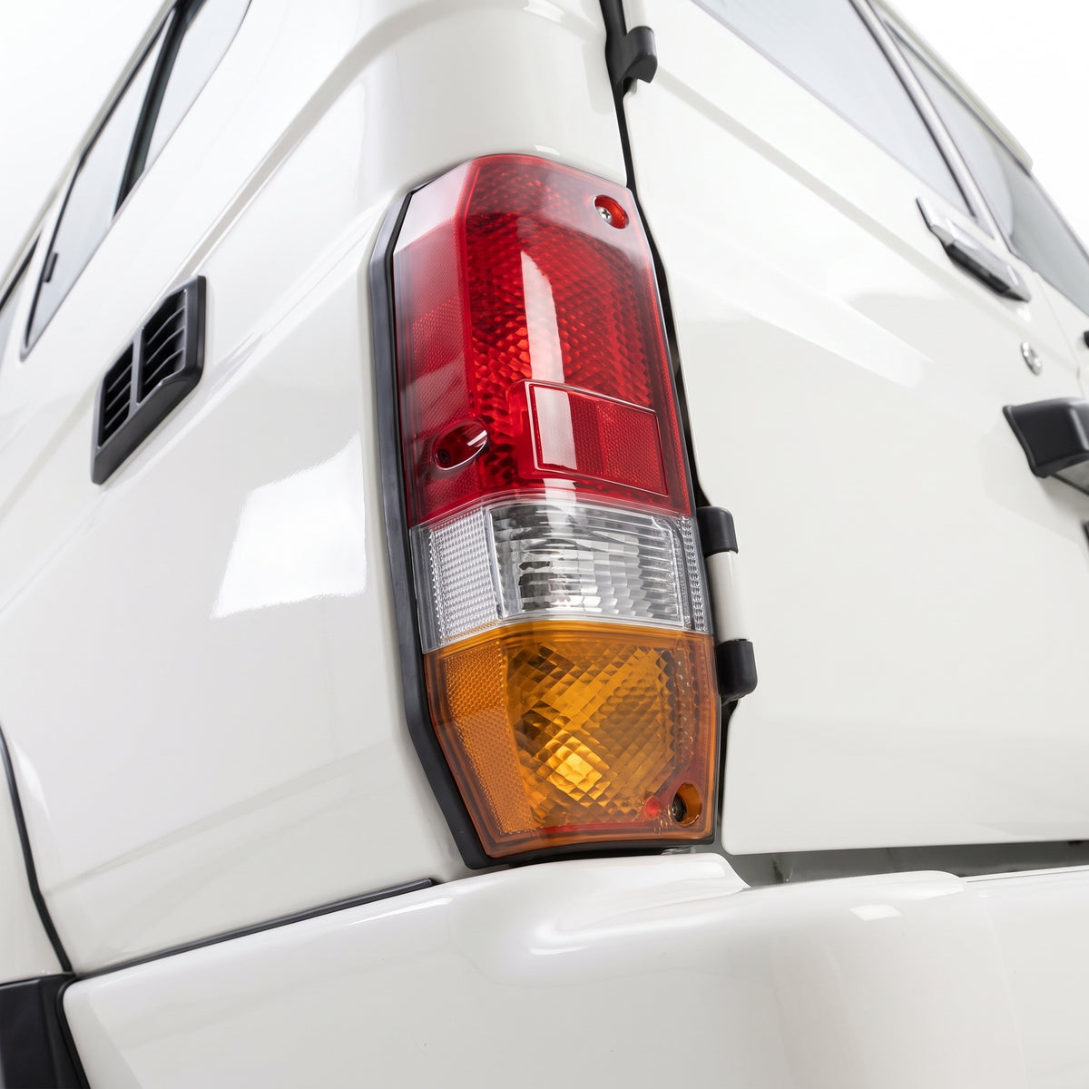Toyota LandCruiser 70 Series (1985 - 1999) OEM Style Tail Lights LH + RH installed close-up