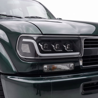 Toyota LandCruiser 80 Series (1990 - 1997) Sequential LED DRL Black Projector Headlights LH + RH installed close-up
