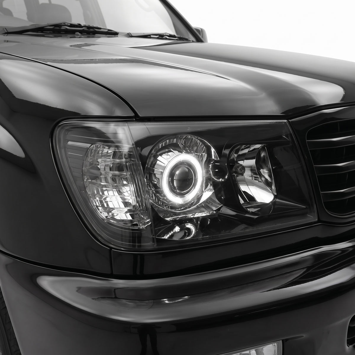 Toyota LandCruiser FJ100 Pre-Facelift (1998 - 2005) Black LED Angel Eye Halo Projector Headlights LH + RH installed close-up